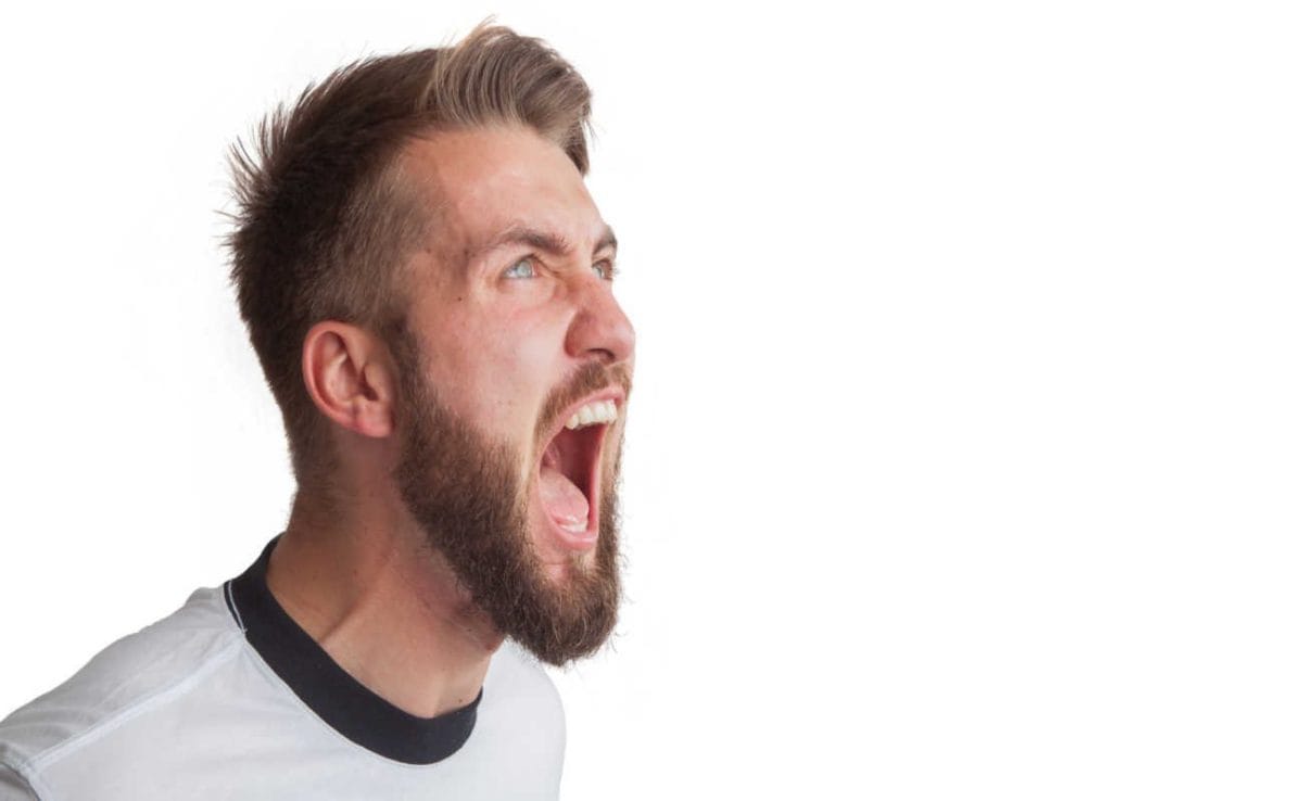 A man shouting with his mouth wide open.