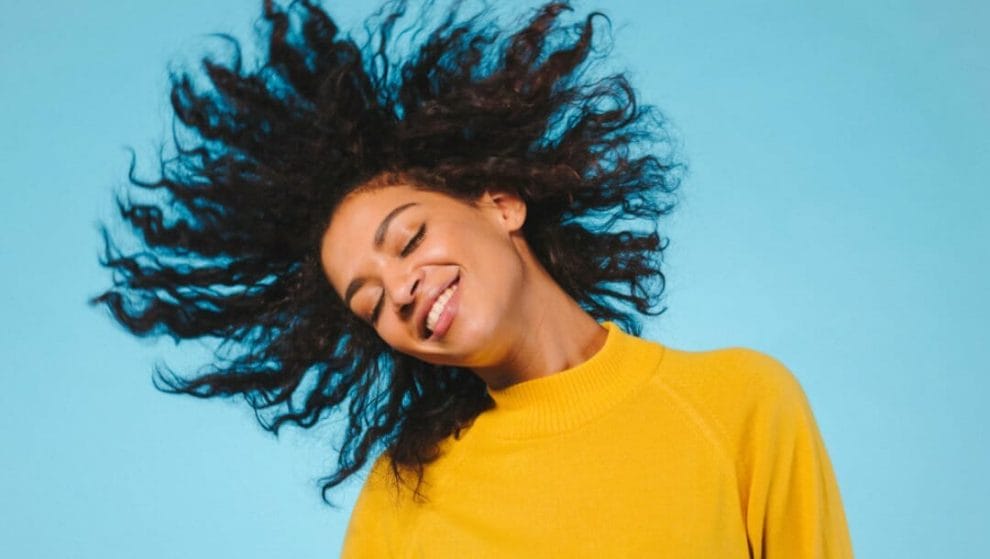 A woman whips her hair around while she dances.