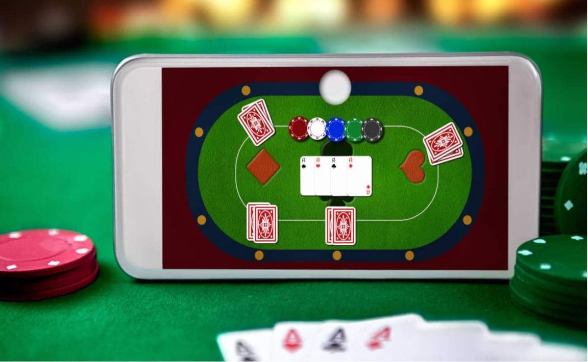 An online poker game on a mobile phone, resting on a real poker table.