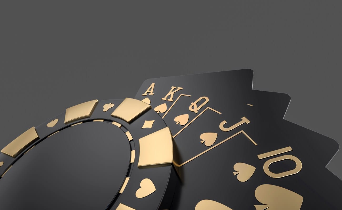 Modern black and gold poker chips and playing cards.