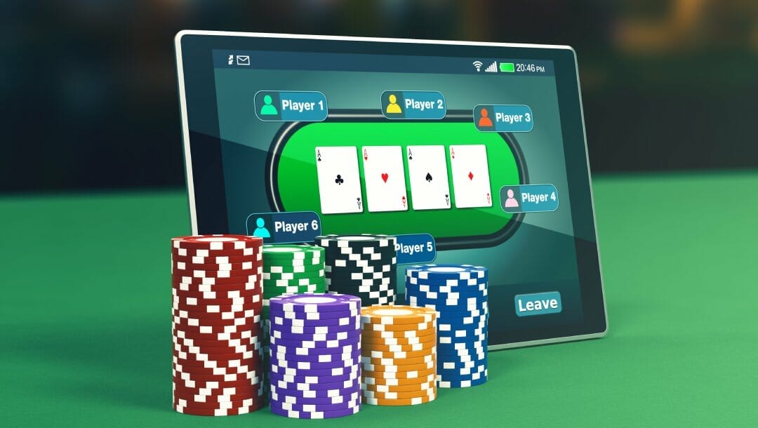 Casino chips placed in front of a tablet with poker on the screen.
