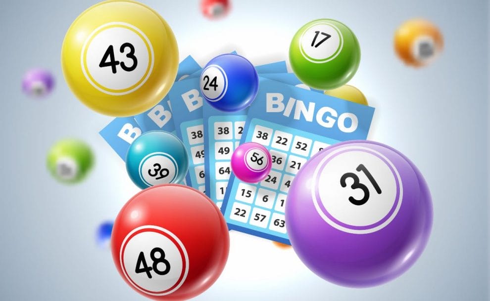 Bingo balls surrounding some blue bingo cards.