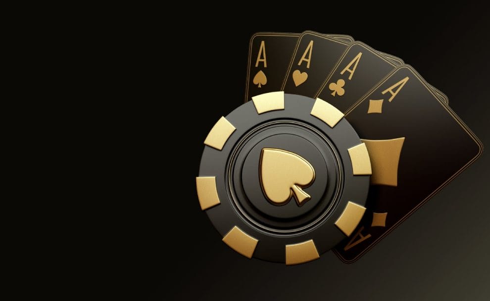  Black and gold poker chip and ace playing cards.