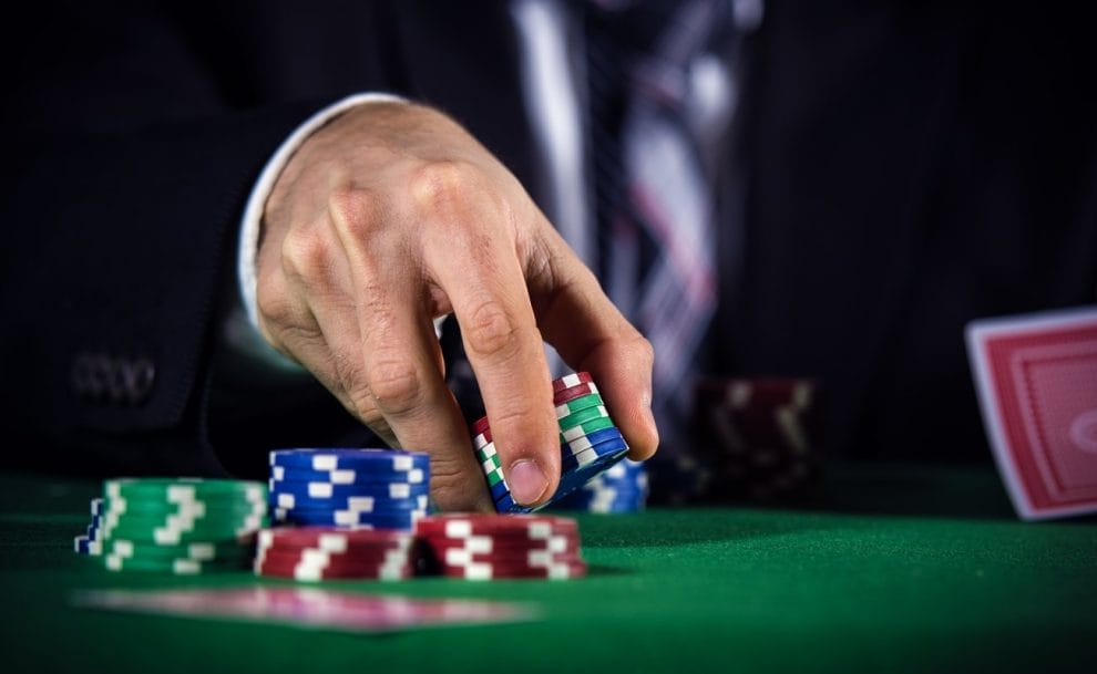 A man raises during a game of poker.