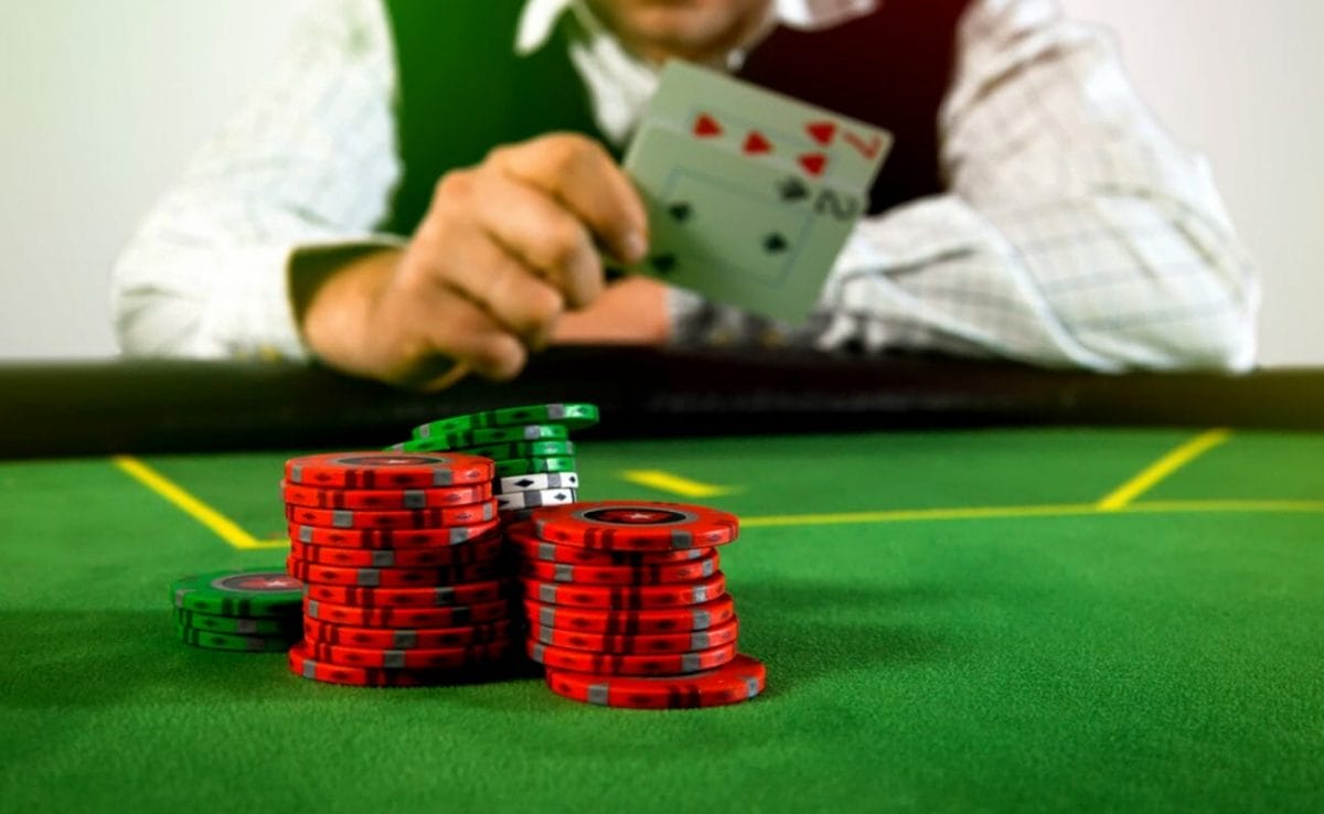A poker player folds his hand of a seven and a two.