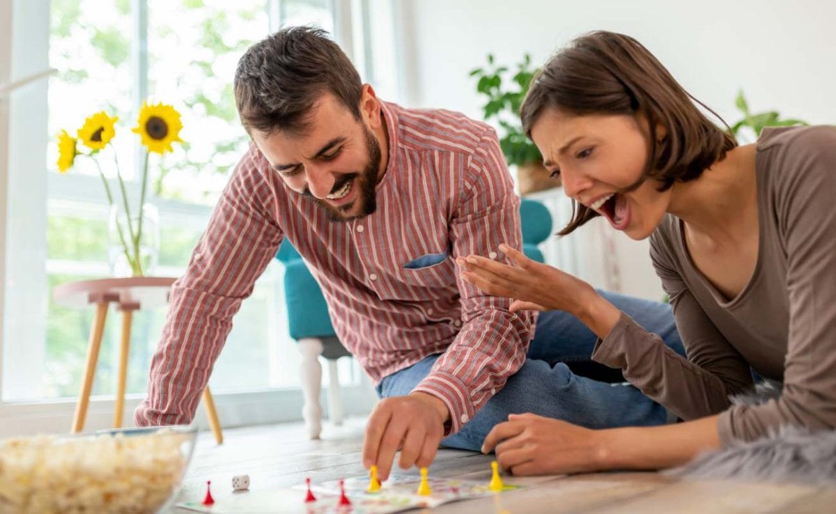 A couple playing a board game together.