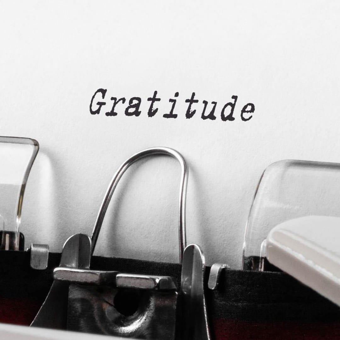 “Gratitude” written on a typewriter page.