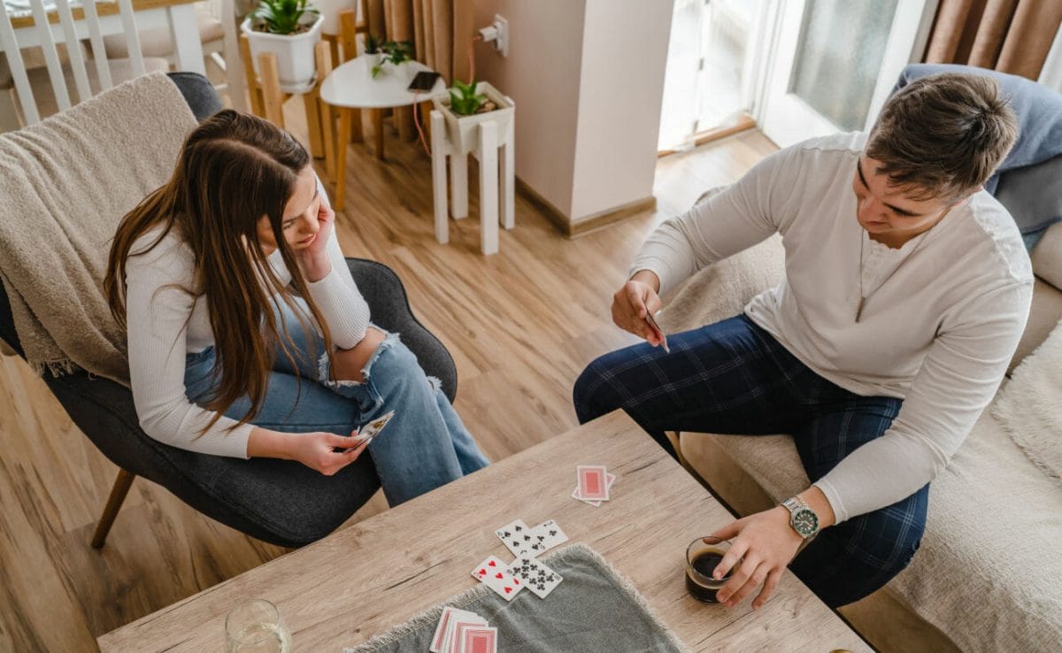 A couple playing card games in their living room.