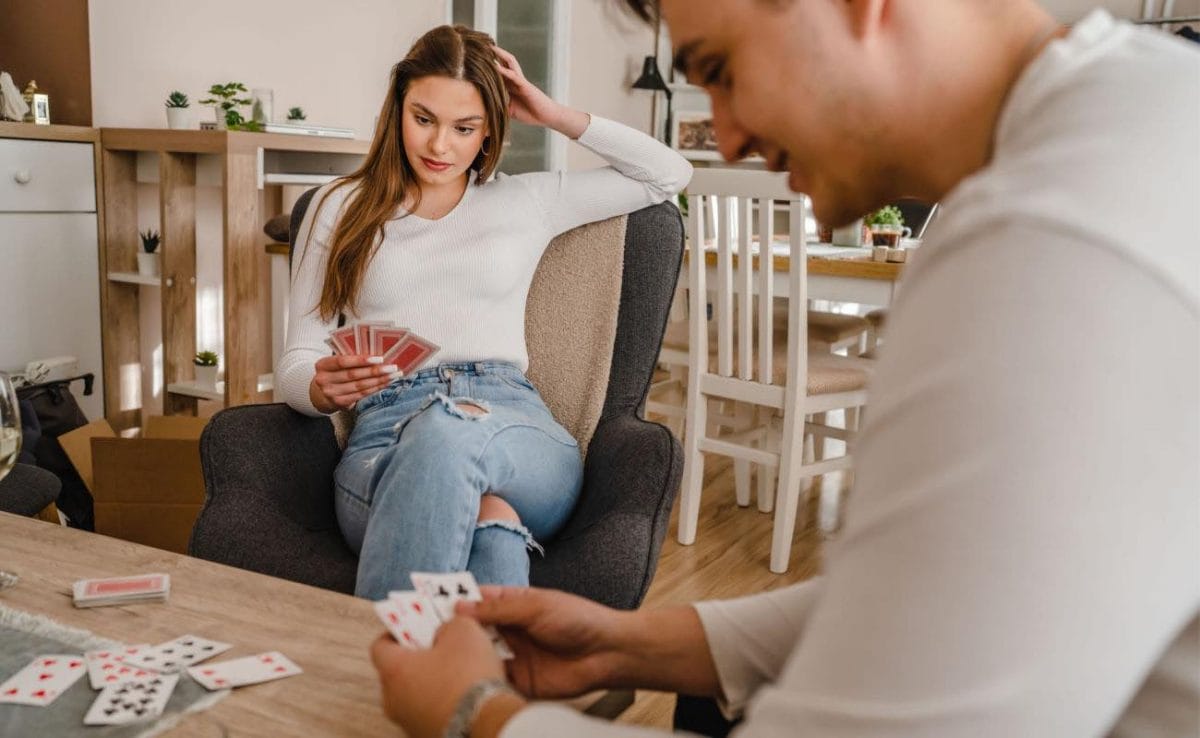 A focused couple playing poker in the living room.