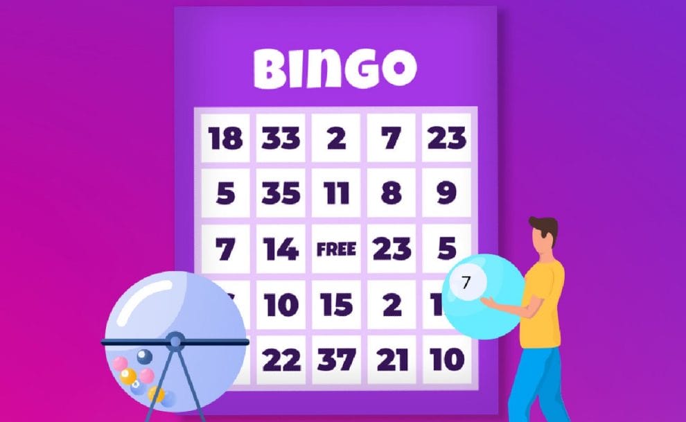 A bingo ball machine, bingo card and a man holding a large bingo ball.