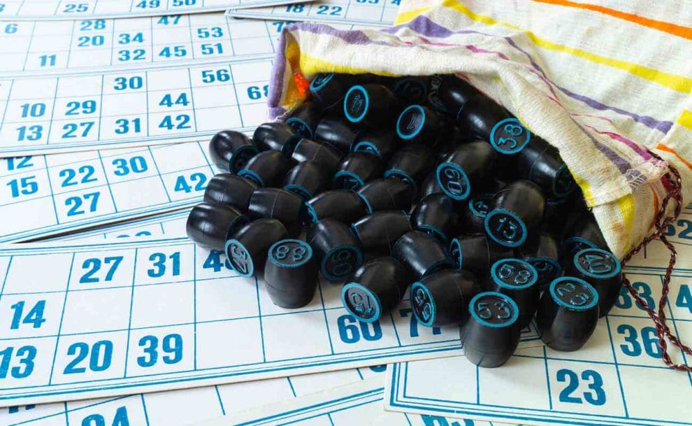 Blue bingo cards next to black and blue bingo casks.