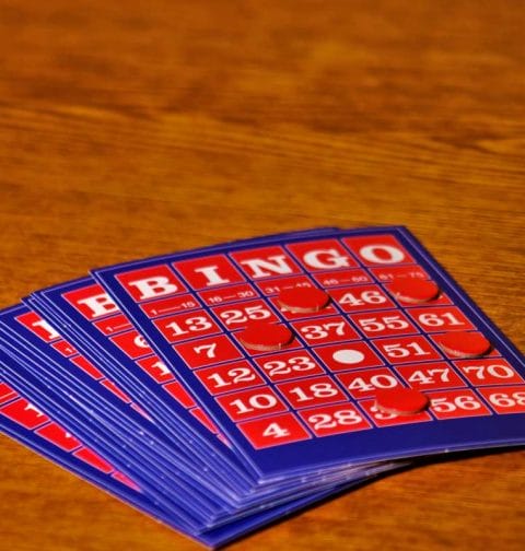 Bingo cards on a wooden table.