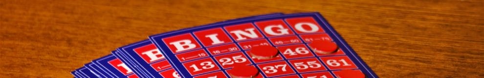 Bingo cards on a wooden table.