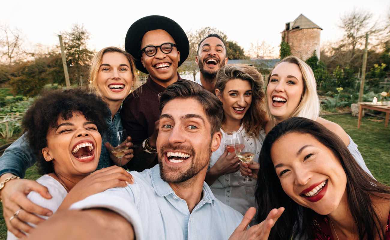 A group of friends taking a selfie at a gathering.