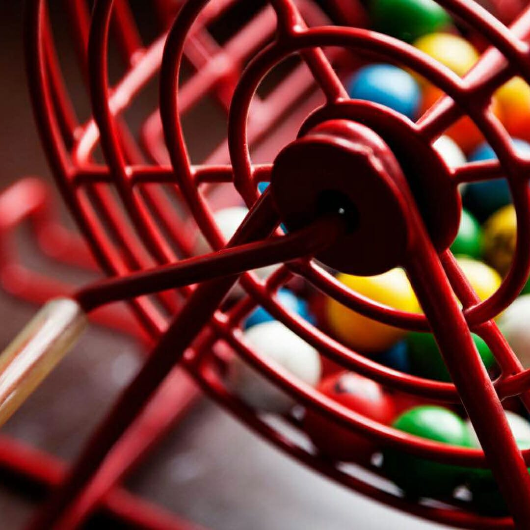 Colorful bingo balls in a bingo cage.