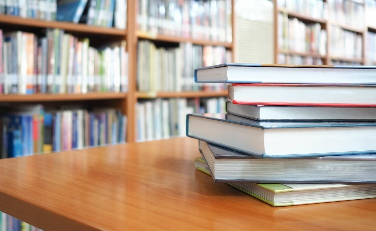 A stack of books on a library table.