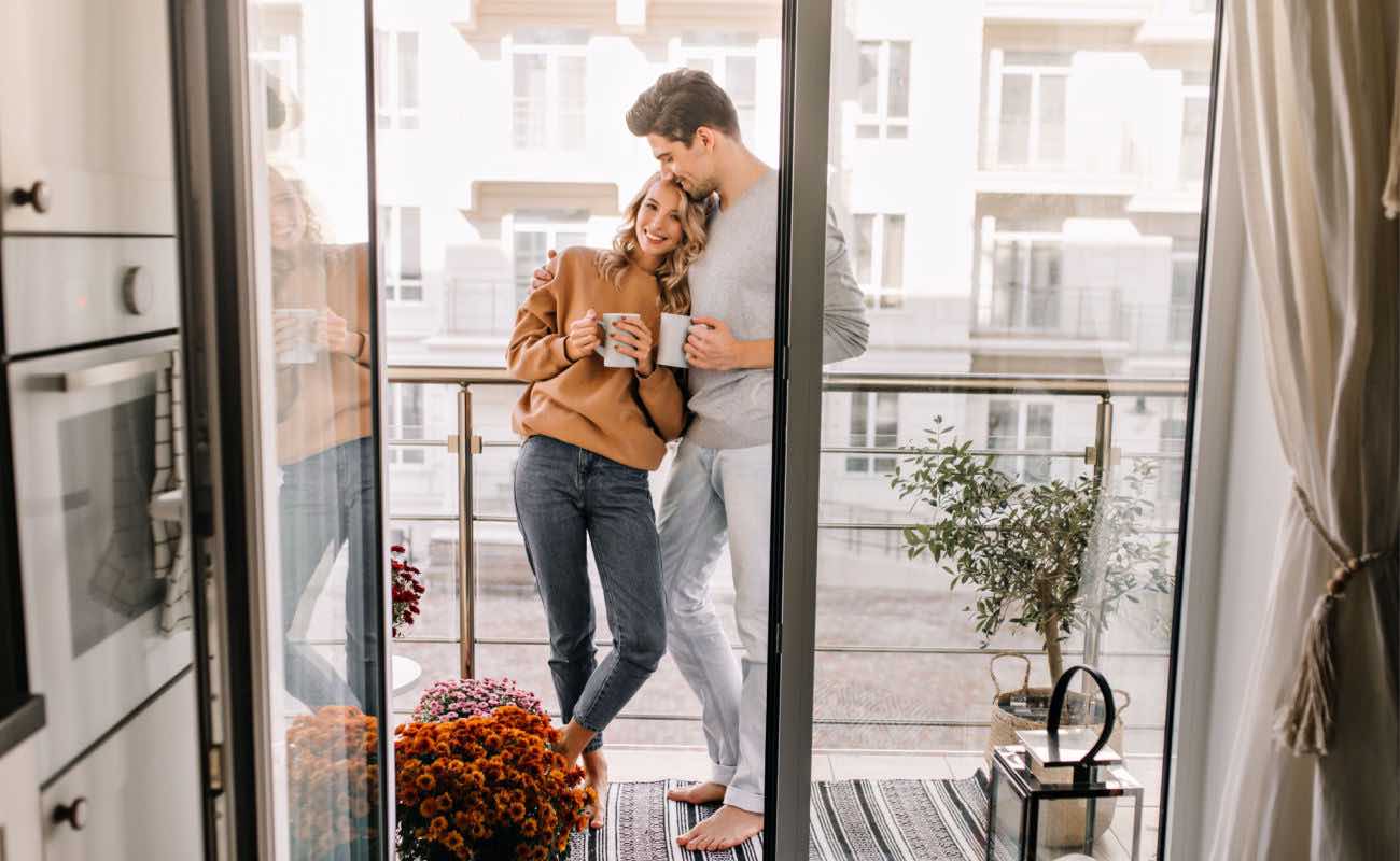 A couple enjoying a cup of tea on the balcony.