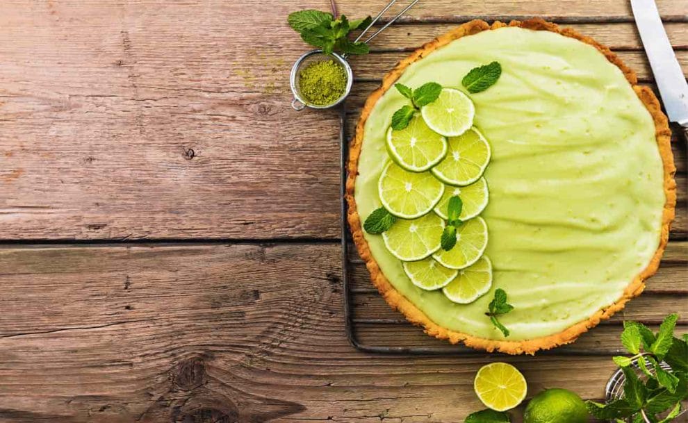 Top view of a Key lime pie on a rustic farmhouse table.