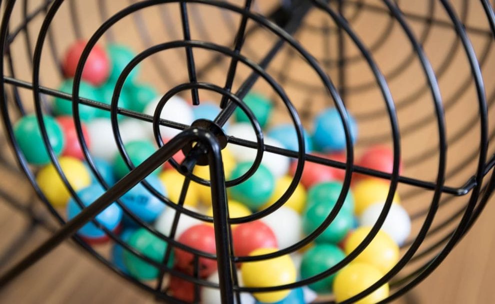 A closeup of a bingo cage filled with bingo balls.