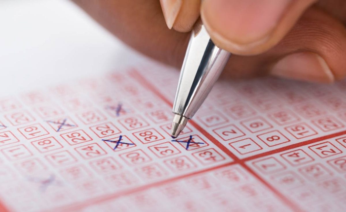 A person crosses out numbers on a card.