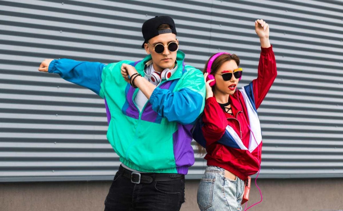 Two people dancing in 80s fashion.