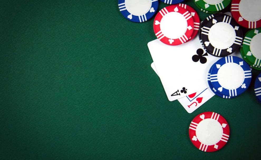 An aerial view of poker chips and cards on a table.