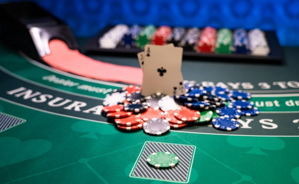 Casino blackjack table with chips and cards.