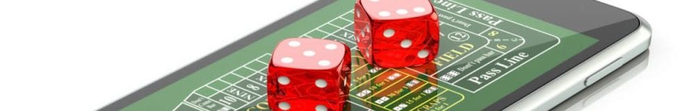 cellphone with online craps on screen and red dices, online gambling concept