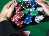 Poker player claiming a huge pot.