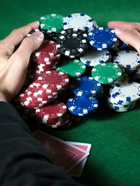 Poker player claiming a huge pot.