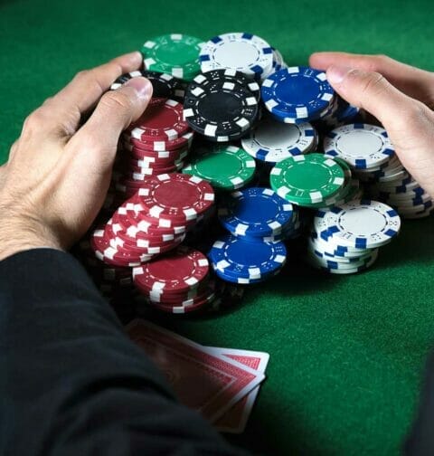 Poker player claiming a huge pot.