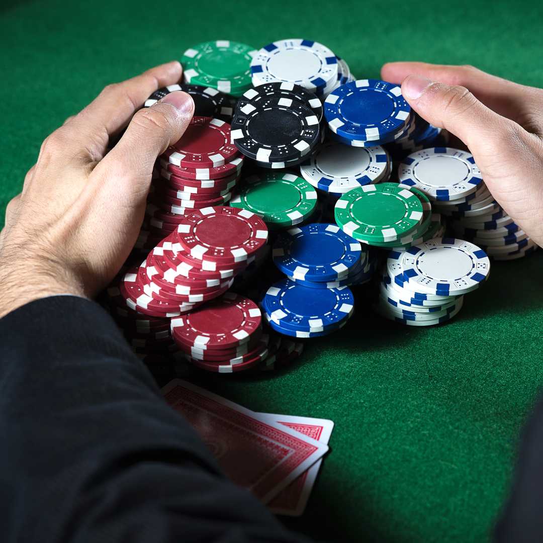 Poker player claiming a huge pot.