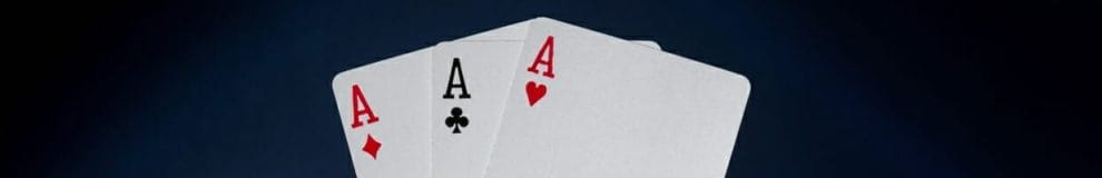 Three aces positioned vertically on a black background.