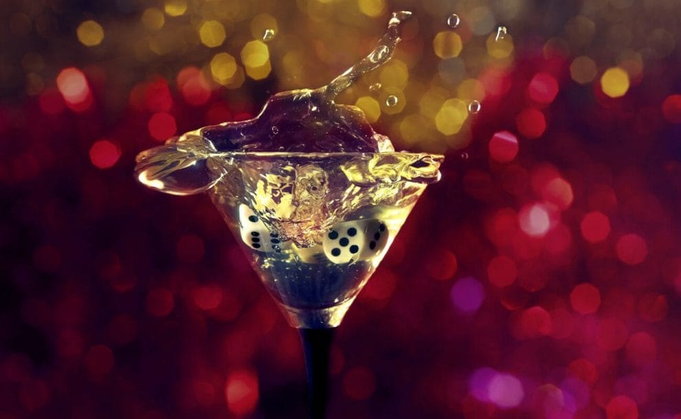 A pair of dice thrown into a full martini glass.
