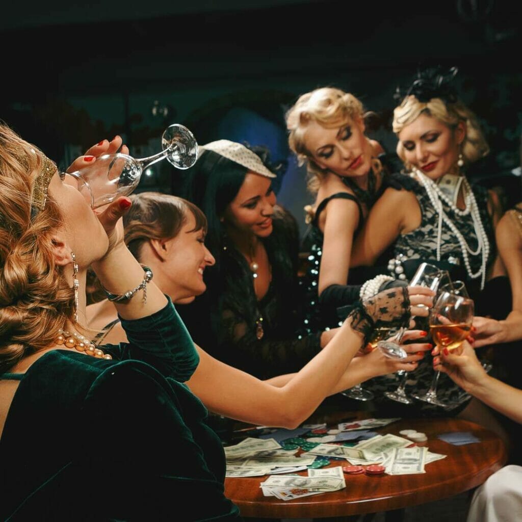 A group of dressed-up partygoers celebrating with glasses of champagne.