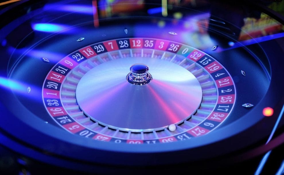 A roulette wheel bathed in blue light.