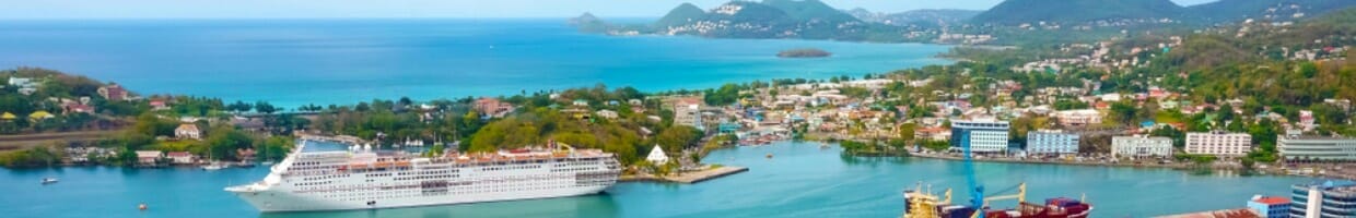 A cruise liner in port with mountains in the background