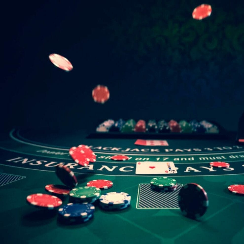 A view of the insurance side bet on a blackjack table with chips and cards.