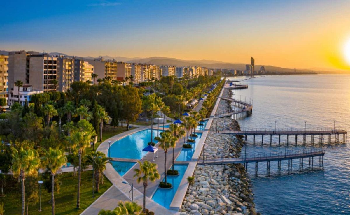 Cyprus seafront with the swimming pools and hotels in the sunset. 