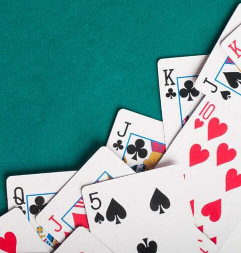 Poker cards on a green felt table.