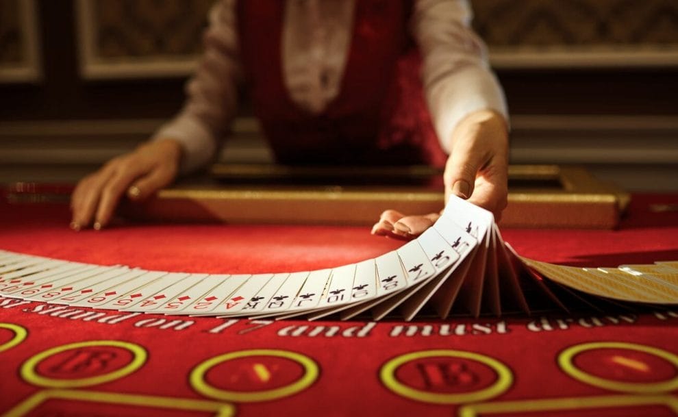 A dealer shuffling cards by hand.
