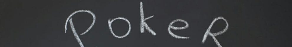 Two cards and the phrase “poker lessons” drawn on a blackboard in white chalk.