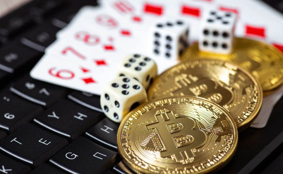 Gold bitcoins scattered among colorful casino chips.
