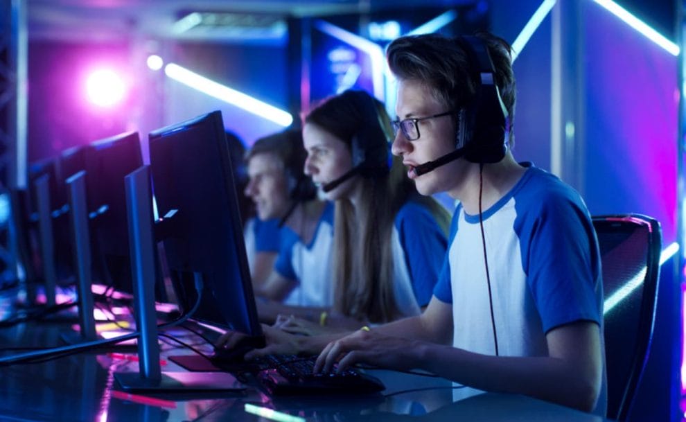 eSports players all sitting in a row at their computers.