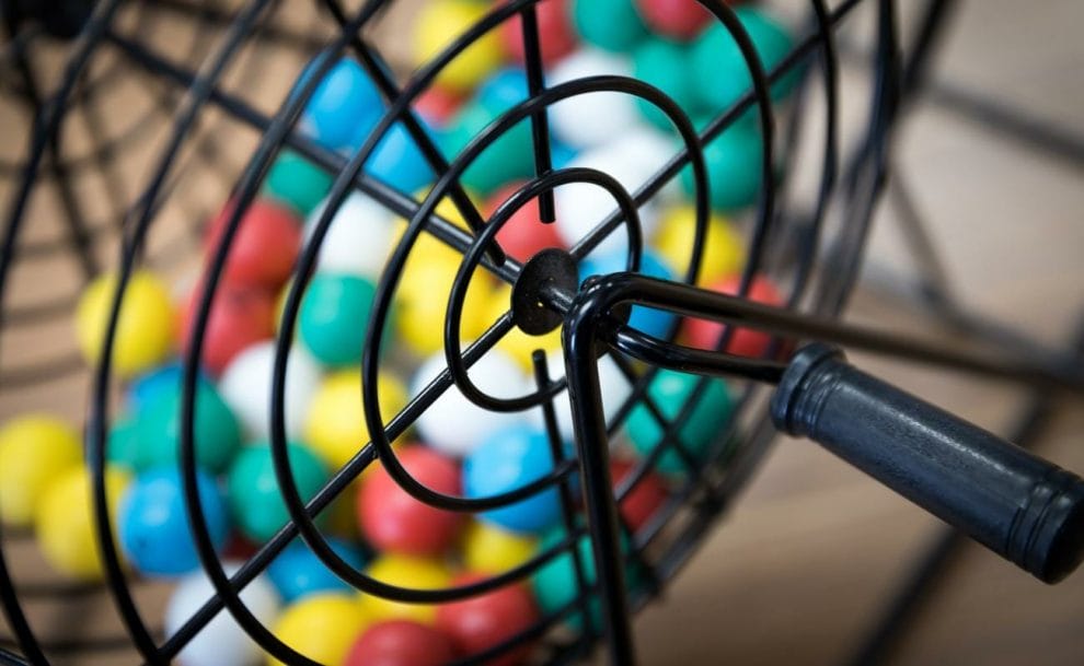 A close-up of a bingo cage filled with bingo balls.