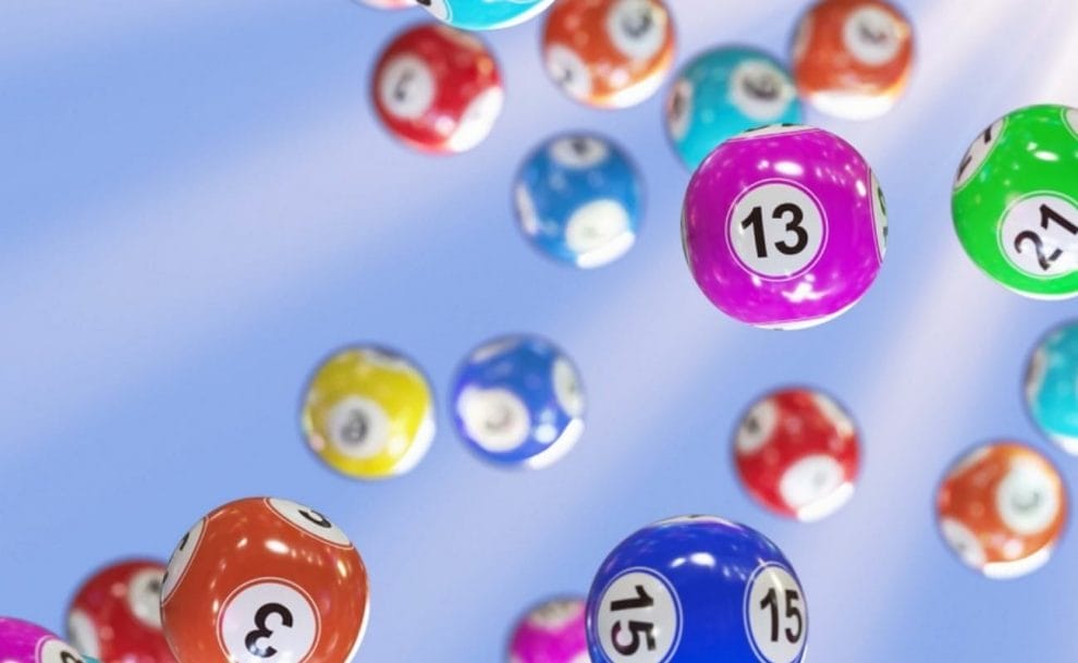  A number of bingo balls floating against a light blue background.