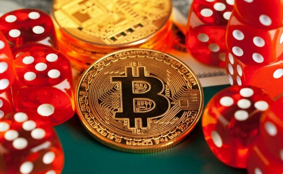 Bitcoin coin and red dice.