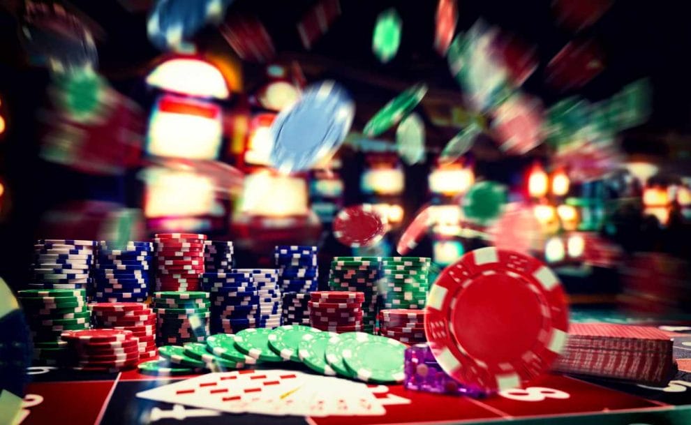 A casino table with poker chips and playing cards.