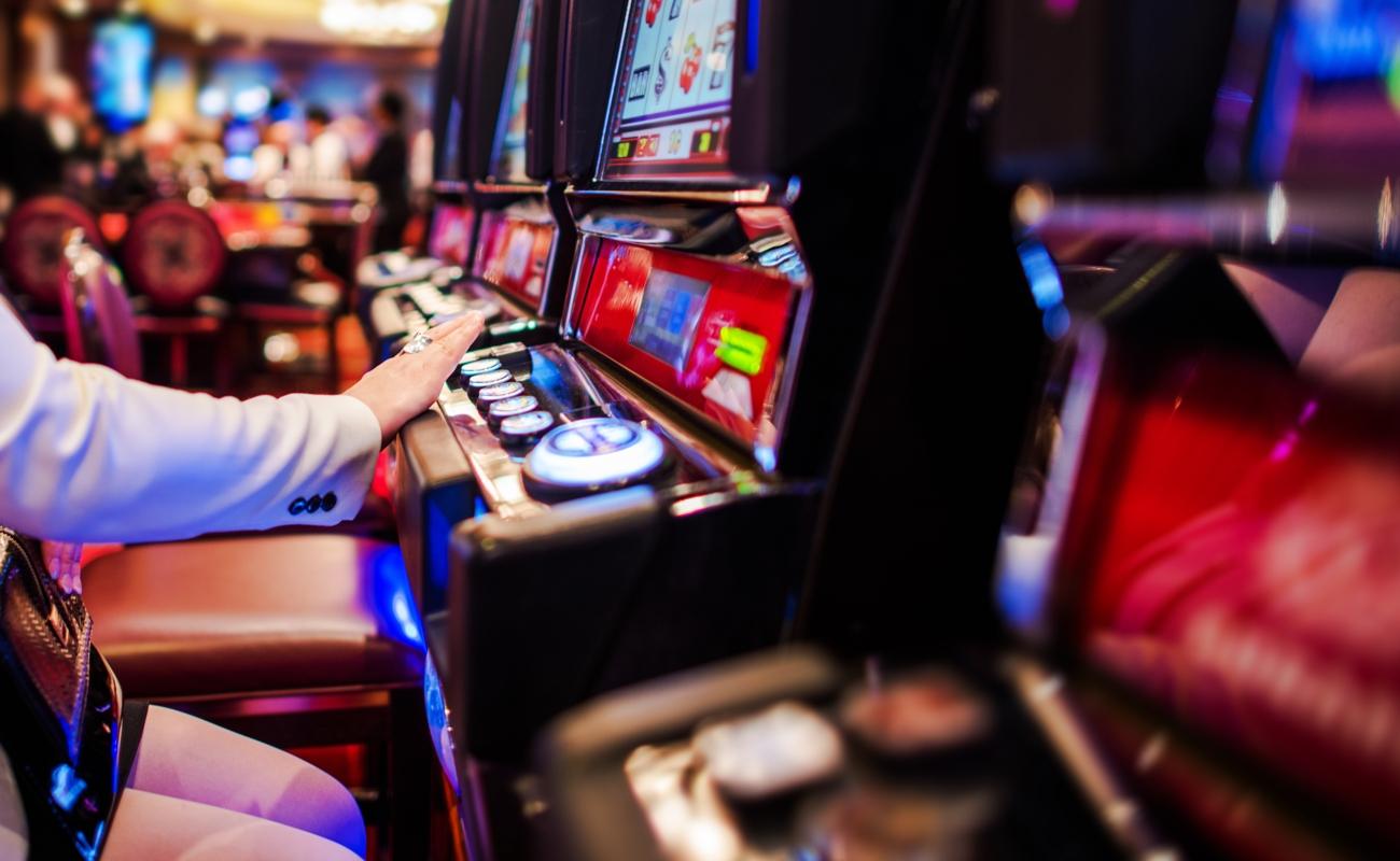  A woman playing slots at a casino.