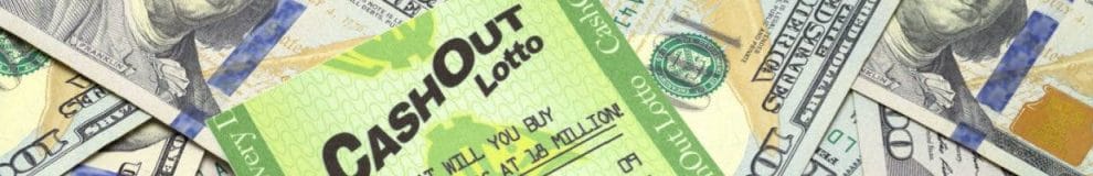 A lottery card on a pile of $100 bills